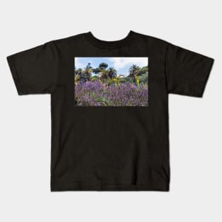 Lush purple sage flowers with palms in the background Kids T-Shirt